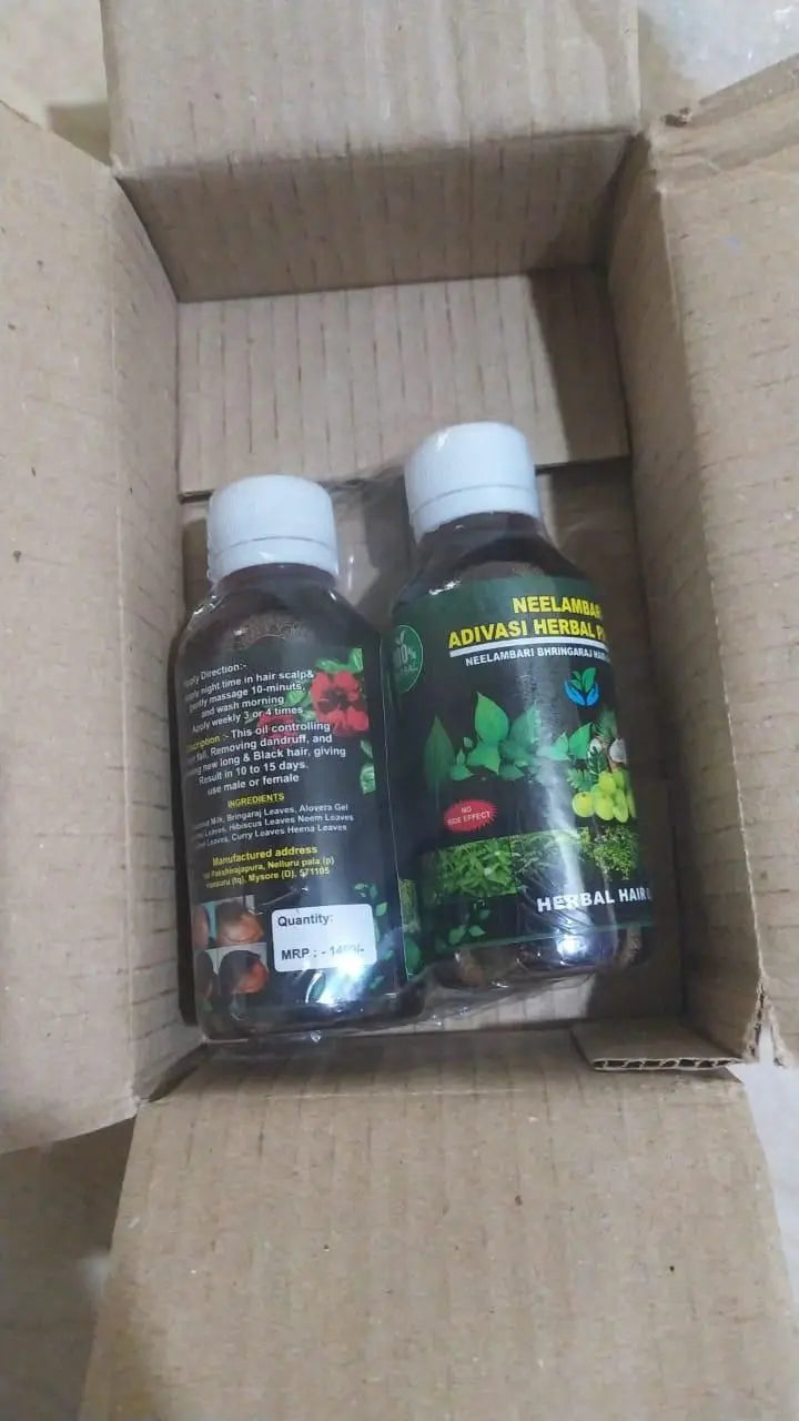 two bottles of natural hair oil in a box.
