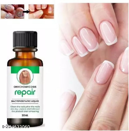 Image of a nail repair oil bottle with a woman's nails on the label displayed from various angles and perspectives, including a close-up view of the label. A small section of wood grain texture is in the top left corner, and a small circular object is in the bottom right corner. Overall, presents a simple representation of the beauty product.