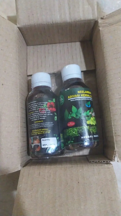	two bottles of natural hair oil in a box.