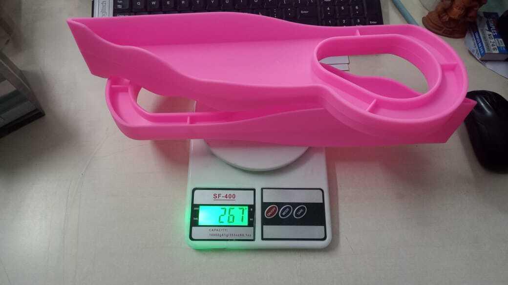 Pink scale with a sleek and modern design displayed on a dark wooden desk with no visible scratches or marks. The focus is on the scale as the main subject.