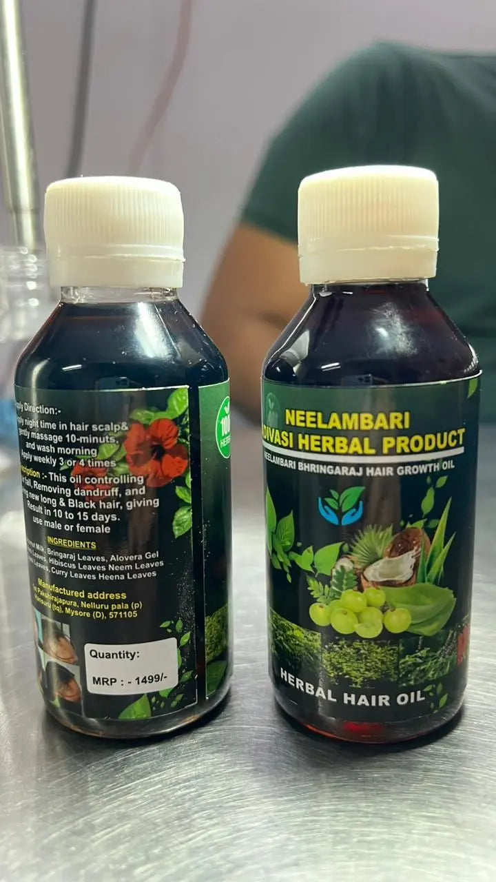 	two bottles of natural hair oil sitting on a table.